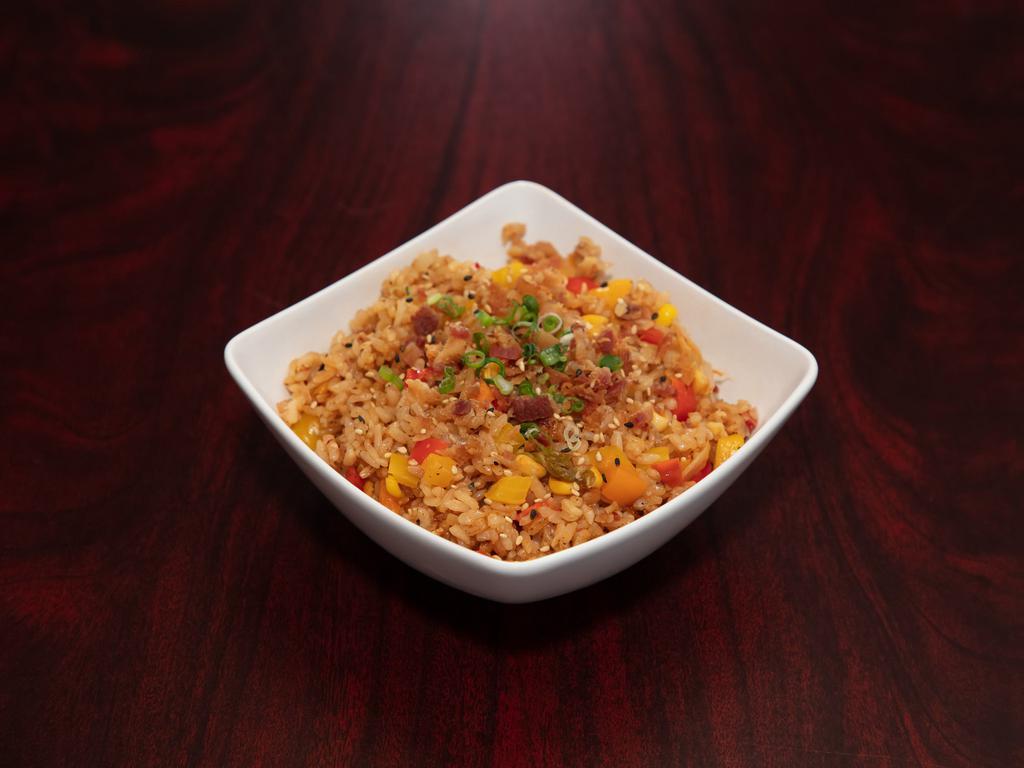 Bacon Kimchi Fried Rice · Savory bell peppers, corn, onion and kimchi with seasoned fried rice. Topped with bits of bacon, green onion and sesame.