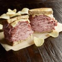 The New York Yankee Sandwich · Combo of hot corned beef and pastrami, Swiss, toasted rye. Served with chips or baked chips.