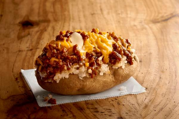 Texas Style Spud · Chopped pit-smoked beef brisket, BBQ sauce, cheddar, butter on a baked potato.  Gluten free.