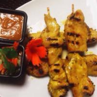 Chicken Satay · Marinated chicken skewers in coconut milk and spices served with peanut sauce and cucumber r...