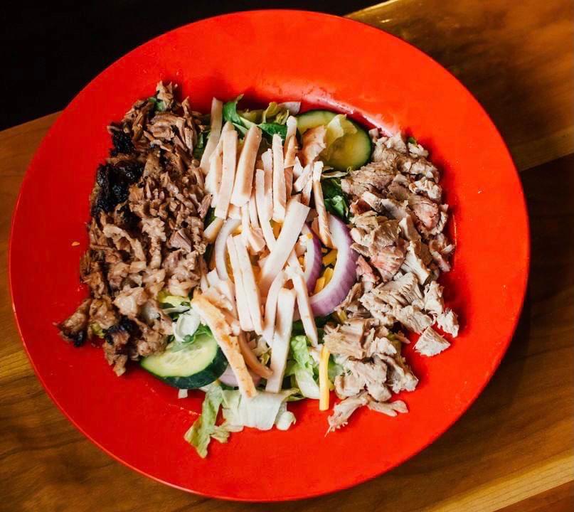 BBQ Salad · Fresh greens topped with your choice of bbq pulled pork, turkey, or beef brisket. Salad toppings include
cherry tomato, cucumber, bell pepper, red onion, &
shredded cheese, with two dressings on the side.