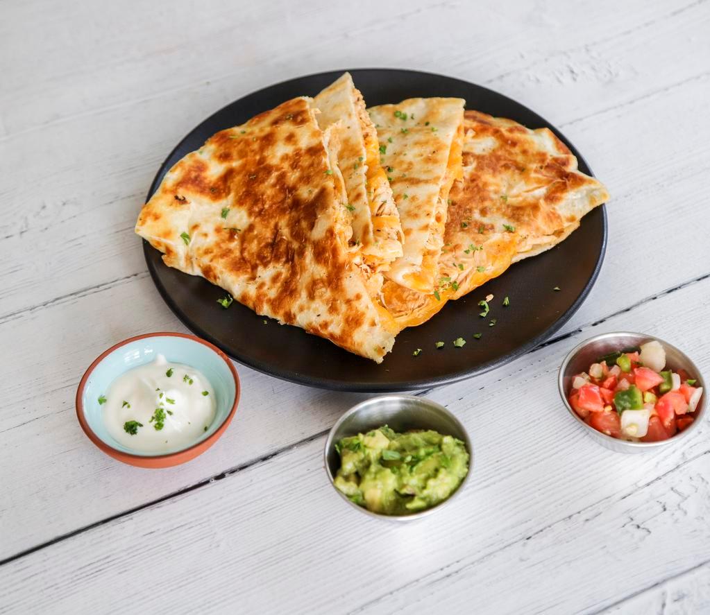 Quesadillas · Fresh flour tortillas, layered with cheese, smoked chicken, pico, guacamole and sour cream. *Can substitute a different meat.