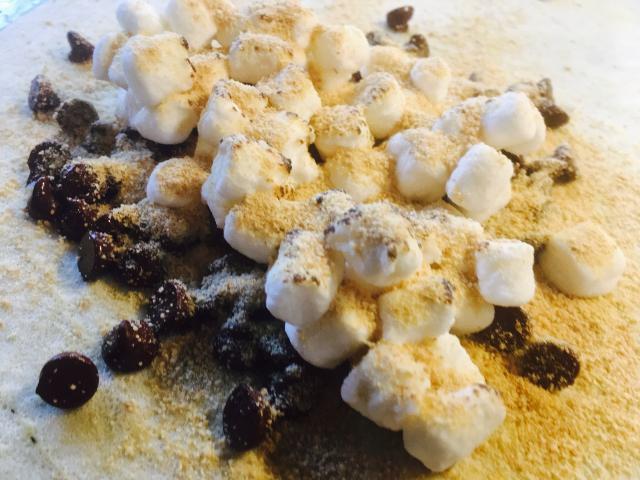 S'mores Crepe · Chocolate chips, graham crumbles, toasted marshmallows, Hershey's syrup and whip cream.
