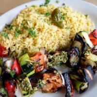 Brochette de Vegetales · 2 skewers of grilled zucchini, eggplant, mushrooms, onion and bell peppers. Served with a ch...
