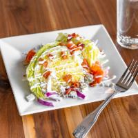Wedge Salad · Bacon bits, blue cheese crumbles, cherry tomato, red onion, blue cheese dressing