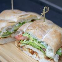 Torta · Mexican style sandwich filled with beans, tomato, avocado, cheese, mayo, lettuce and jalapeno.