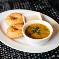 Medhu Vada · 2 piece. Doughnut shaped South Indian fritter made with ground lentil batter. Served with sa...