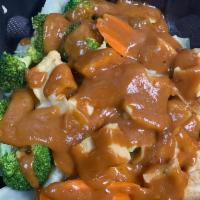 57. Pra Ram · Served with steamed broccoli, cabbage and carrots topped with peanut sauce.