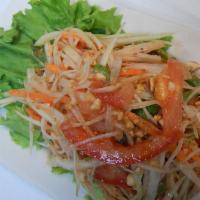 17. Papaya Salad · Shredded green papaya and sun-dried shrimp mixed with tomatoes and string beans in spicy lim...