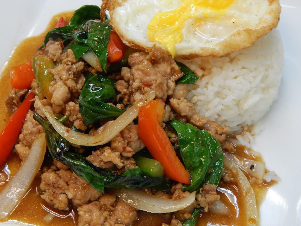 Dinner Krapow Gai Khai Daao · Sauteed ground chicken with fresh basil leaves, red peppers, green peppers, and onions in a spicy chili and garlic sauce. Served with a sunny side up fried egg. Spicy.