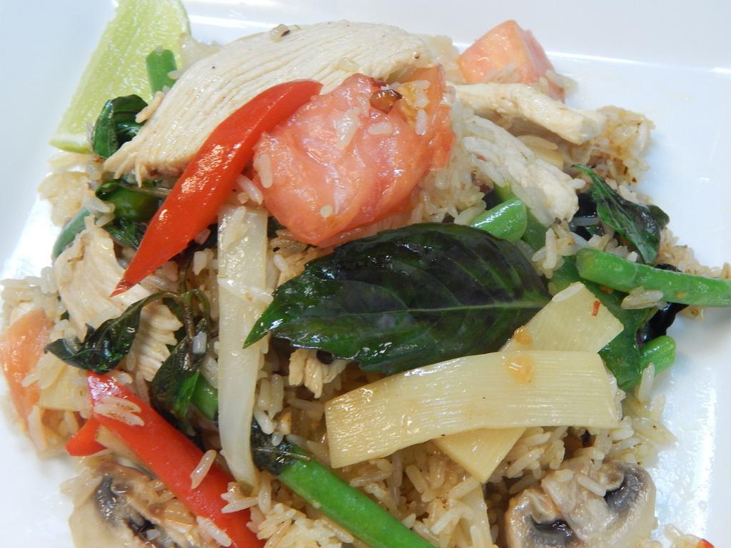 Khao Pad Krapow · Thai fried rice with bamboo shoots, string beans, onion, tomatoes, bell peppers, basil, and chili garlic sauce. Spicy.