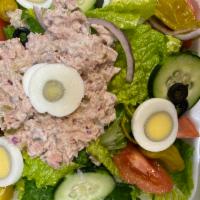 Tuna Salad · Two mounds of tuna salad on a bed of mixed lettuce, garnished with tomatoes, cucumber, onion...
