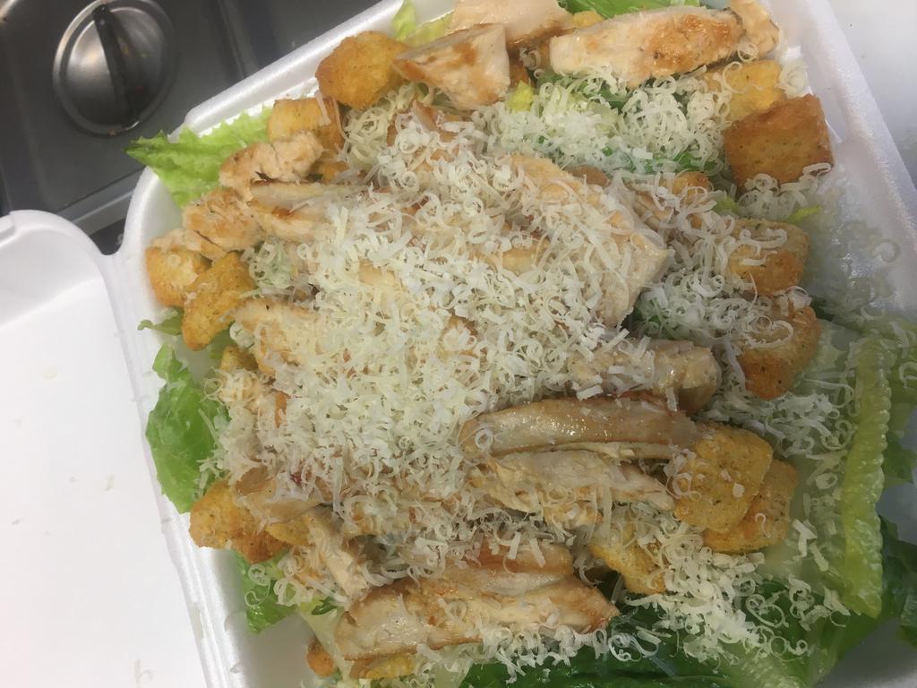Grilled Chicken Caesar Salad · Marinated grilled chicken on top of romaine lettuce, croutons and Parmesan cheese with Caesar dressing.