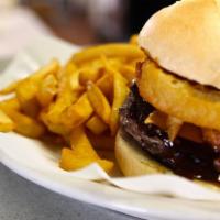 Cowboy Burger · 100% ground beef topped with cheese, BBQ sauce and onion rings served on a hot bun with lett...