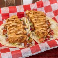 Fish Tacos (2) · Crispy fried fish filets served on warm corn tortillas over lettuce, topped with pico de gal...