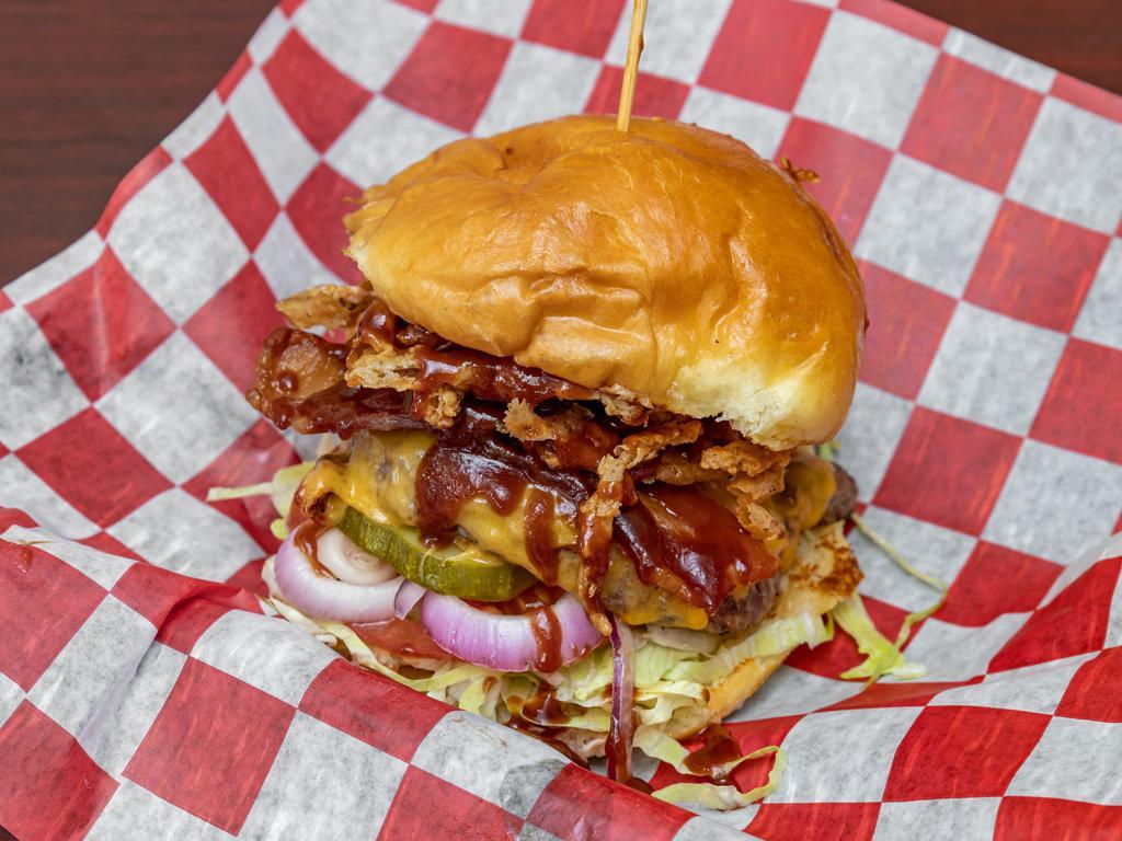 Rodeo Burger · Our classic single 5 oz Angus burger topped with Bacon, Melted Cheddar, Crispy Fried Onions and our Kansas City BBQ on our toasted brioche bun
