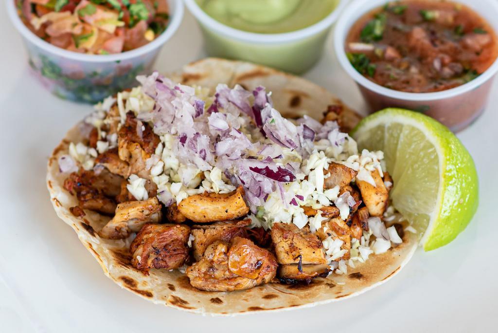 Chicken Taco · Pollo street taco marinated with citrus and anchiote seasoning. Topped with diced cabbage and red onion. Choice of corn or flour tortilla.