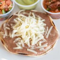 Bean and Cheese Tostada · Crisp corn tortilla topped with melted Monterey Jack cheese and refried beans.