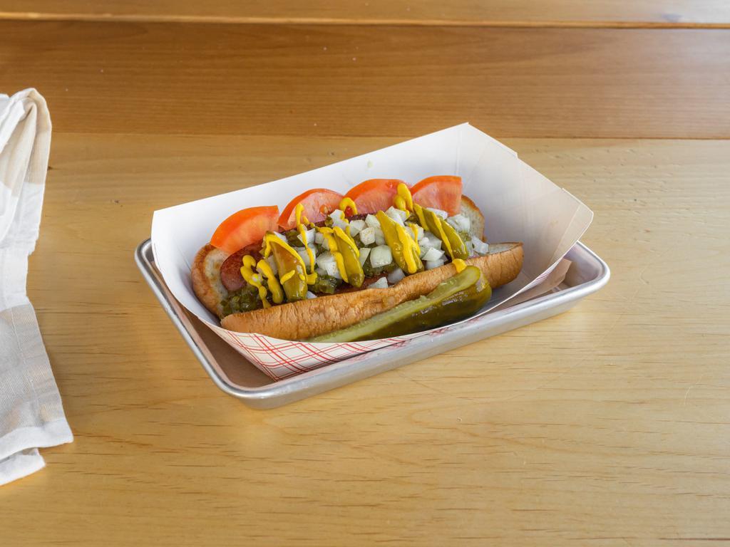 The Chicago Dog · Served with relish, onion, tomato, cucumber, pickle, sport peppers, celery salt, and mustard. 100% Neiman ranch beef.