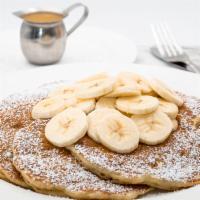 Fresh Banana Pancakes · Served with tropical syrup, freshly whipped cream and powdered sugar.