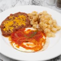 Huevos Rancheros · 2 eggs over medium, homemade ranchero sauce, homestyle potatoes and refried beans. Spicy. Se...