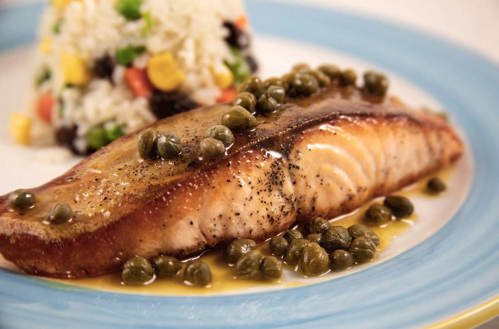 Pan-Seared Salmon · Served with vegetable rice and raisins and topped with passion fruit glaze and capers. Served with Rice & Beans