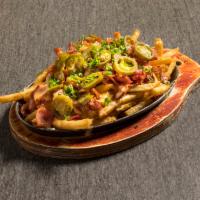 Cheese Bacon Fries · Fried potatoes topped with cheese and chili.