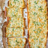 Cheesy Garlic Bread · Fresh Italian bread topped with garlic, lots of mozzarella cheese cut into strips for dipping.