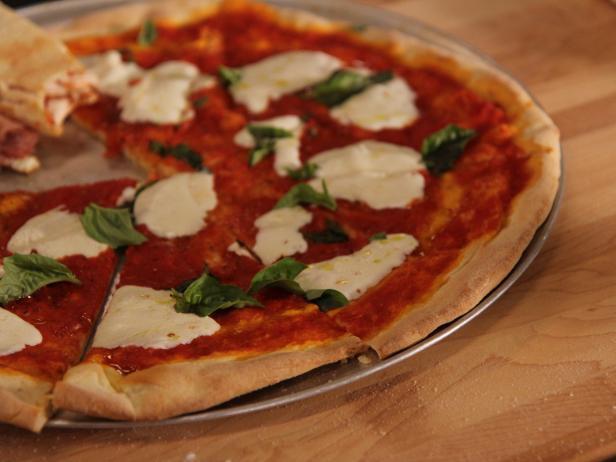 Margherita Pizza · Sliced Tomatoes, Fresh Basil, Fresh Sliced Mozzarella Extra Virgin Olive Oil and Parmesen Cheese.