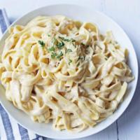 Fettuccine Alfredo · Fettuccine pasta in our in house madxe by the order alfredo sauce baked with mozerella chees...