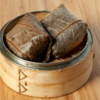 Lotus Rice Wrap - 珍珠糯米鸡 · Sticky rice with Pork, Sausage, Mushroom, and Salted Egg filling; wrapped in a banana leaf, ...