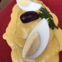 Papa a la Huancaina · Contain gluten. Potatoes, Andean cream sauce of feta cheese ají amarillo with botija olive a...
