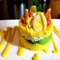 Chicken Causa · Contain gluten. Whipped potato cake spiced with aji amarillo and lime, served with chicken s...