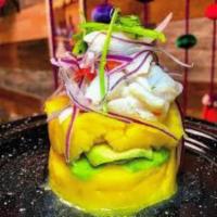 Ceviche with Causa · Whipped potato cake spiced with ají amarillo and lime, sliced avocado, and topped with cevic...