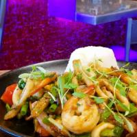 Seafood Stir Fry · Sauteed seafood with onions, tomato wedges, garlic and fries, tossed in a rich soy demi-glaz...