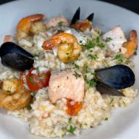 Seafood Risotto  · Shrimp, scallops, mussels, salmon, roasted garlic, roasted shallots, roasted tomatoes, parme...