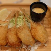Crispy Shrimp Lollipop  · 4 pcs crispy breaded shrimp skewers served on bed of cabbage with side of yuzu kosho aioli s...