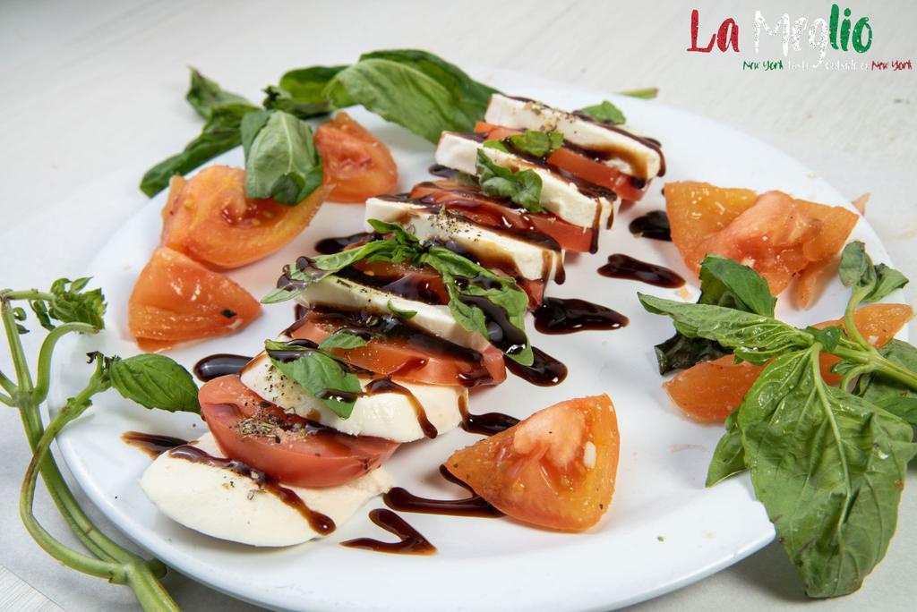 Caprese Salad · Sliced tomato, fresh mozzarella, aged balsamic, olive oil and fresh basil.