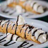 Cannoli · Classic Italian shell pastry filled with ricotta mascarpone blend with chocolate drizzle.