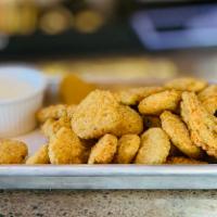 Crispy Southern Deep Fried Pickles · Pickle chips battered and fried to a perfect golden brown. Served with our spin on a ranch d...