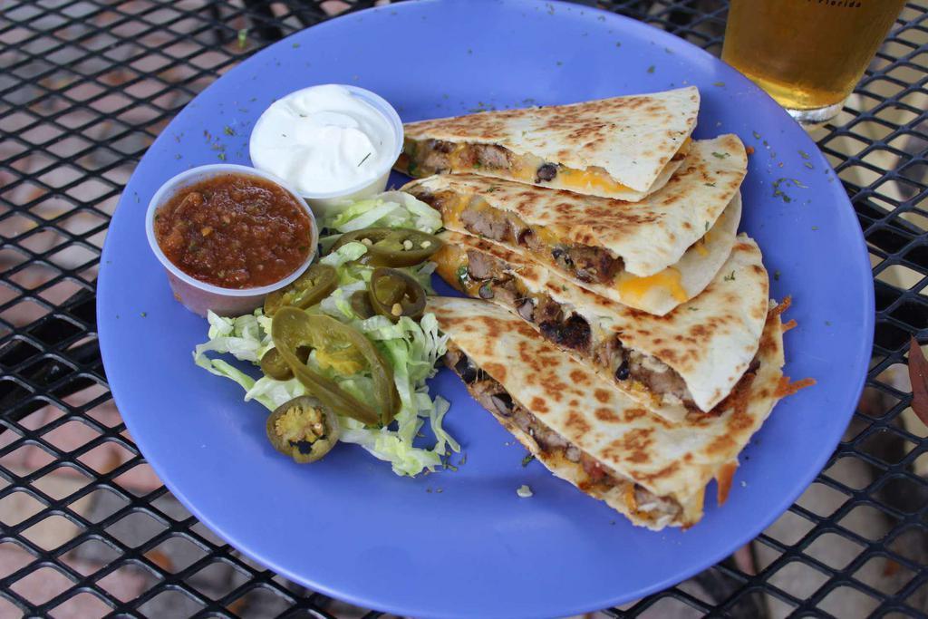Chimichurri Steak Quesadilla · Chimichurri marinated steak, shredded cheddar jack cheese, black beans and roasted corn salsa, grilled in a flour tortilla and served with a side of sour cream, salsa, lettuce and pickled Jalapenos.