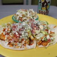 Buffalo Chicken Tacos · Our fried chicken tossed in our Buffalo sauce, shredded cheddar jack cheese, pico de gallo, ...