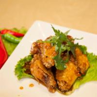 A9. Fish Sauce Chicken Wings · Deep-fried chicken wings with caramelized fish sauce.