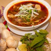 Spicy Beef Noodle Soup · Spicy beef soup with beef shank, Vietnamese ham, pork blood and steamed pork leg.