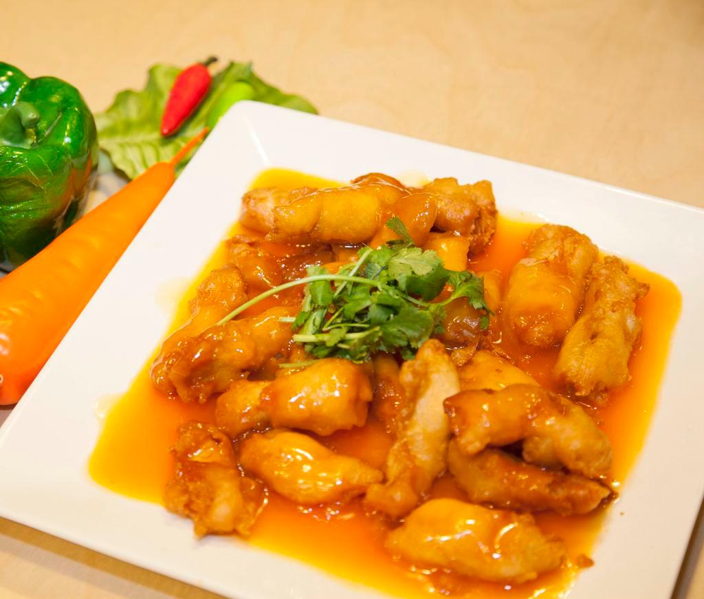 R13. Orange Chicken · Mixing crispy chicken and orange sauce with steam rice.
