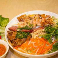 V1. Bun Dac Biet · Grilled pork, shrimp, Vietnamese sauge patty and egg rolls with vermicelli bowl.