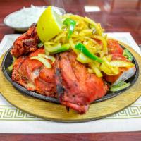Tandoori Chicken Special · Skinless chicken marinated in a mixture of yogurt and savory spices cooked in the tandoor.