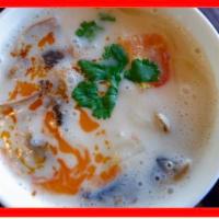 Tom Kha Coconut Soup · A distinctively flavored Thai coconut soup with mushroom, tomato, fresh galangal, lemongrass...