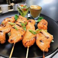 Chicken Satay Bites · Marinated and grilled chicken breast cutlets served with a sweet vinegar cucumber melange an...