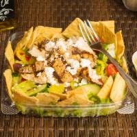 Fattoush Salad · Romaine hearts, tomato, cucumber, olives, feta cheese, pita chips and banana pepper with lem...